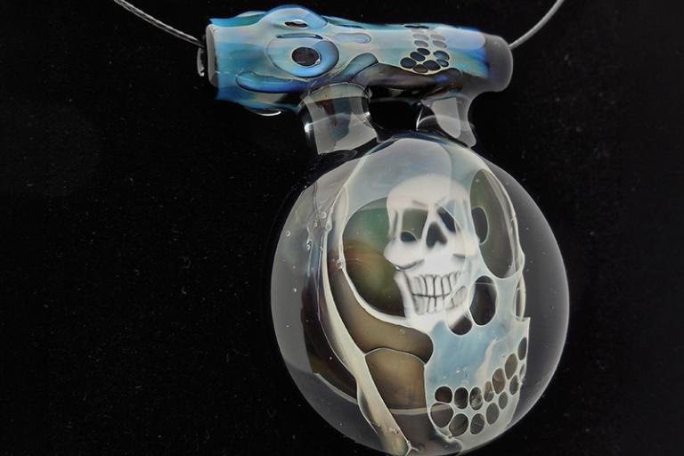 Image of glass pendant with skull imagery by Hugh Salkind